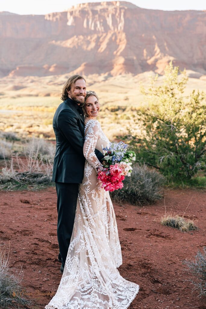 elopement couple hugging during their western elopement in moab