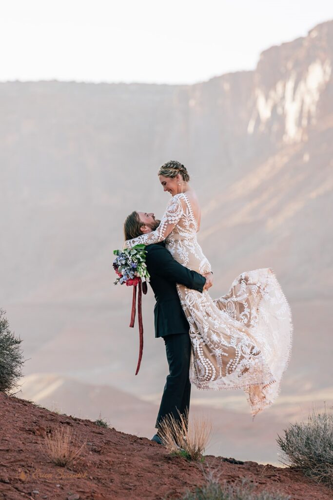 playful elopement couple in the red desert in moab