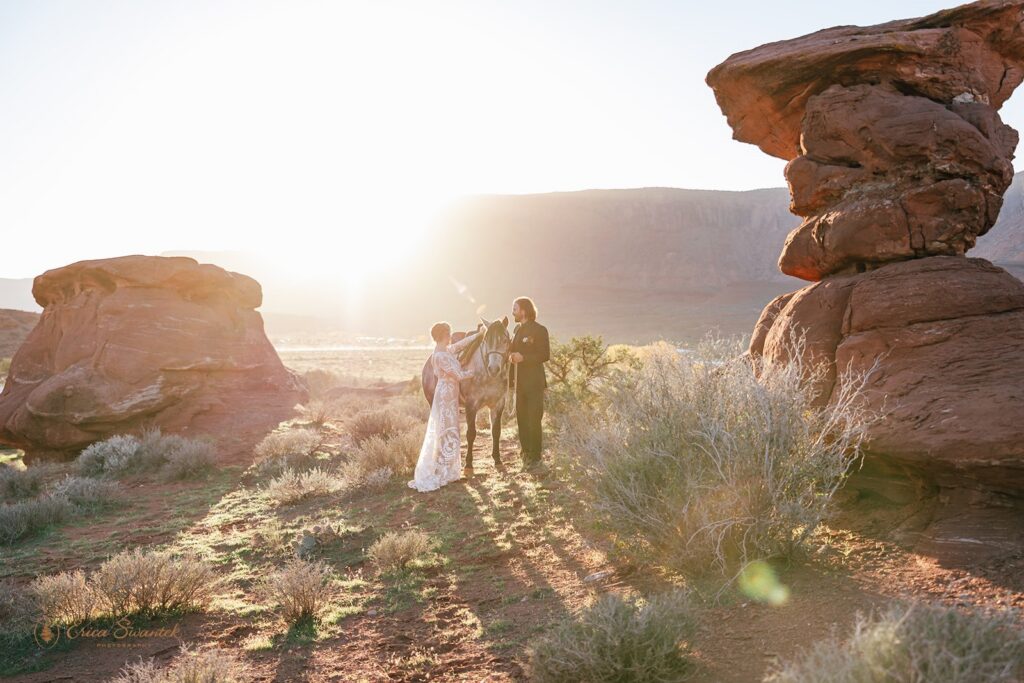 elopement couple posing with their horse during their western elopement in moab