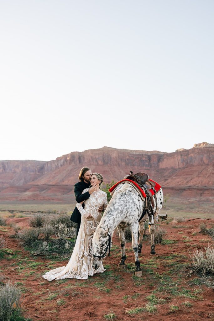 adventurous elopement couple with a horse during their moab elopement day