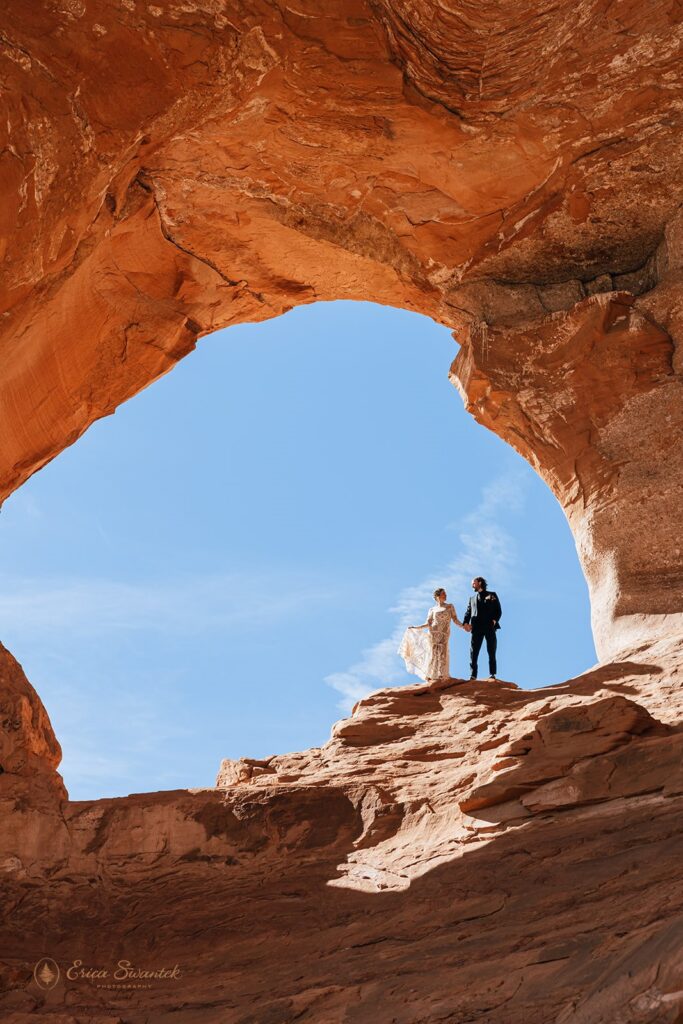 bride and groom at the looking glass arch during their moab elopement