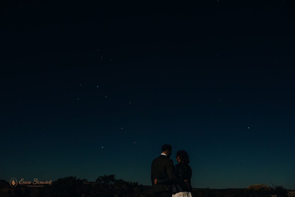 elopement couple gazing upon stars during their moab elopement