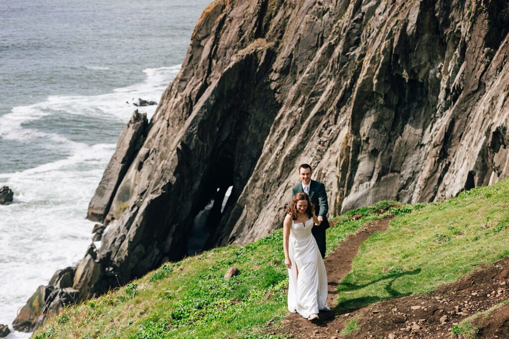 playful bride and groom during their pnw elopement along the coast