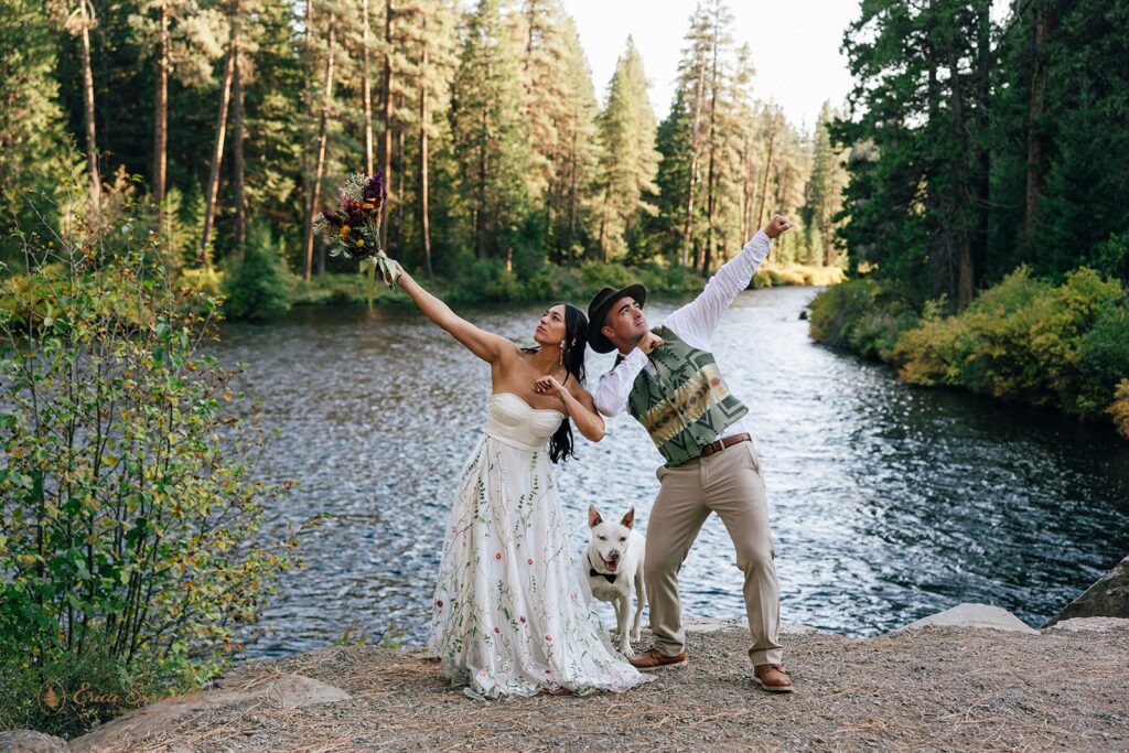 playful elopement couple surrounded by lush forest in front of a river during their pnw elopement