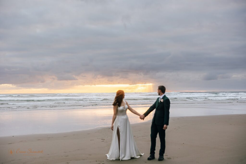bride and groom watching the sunset during their pnw elopement on oregon coast