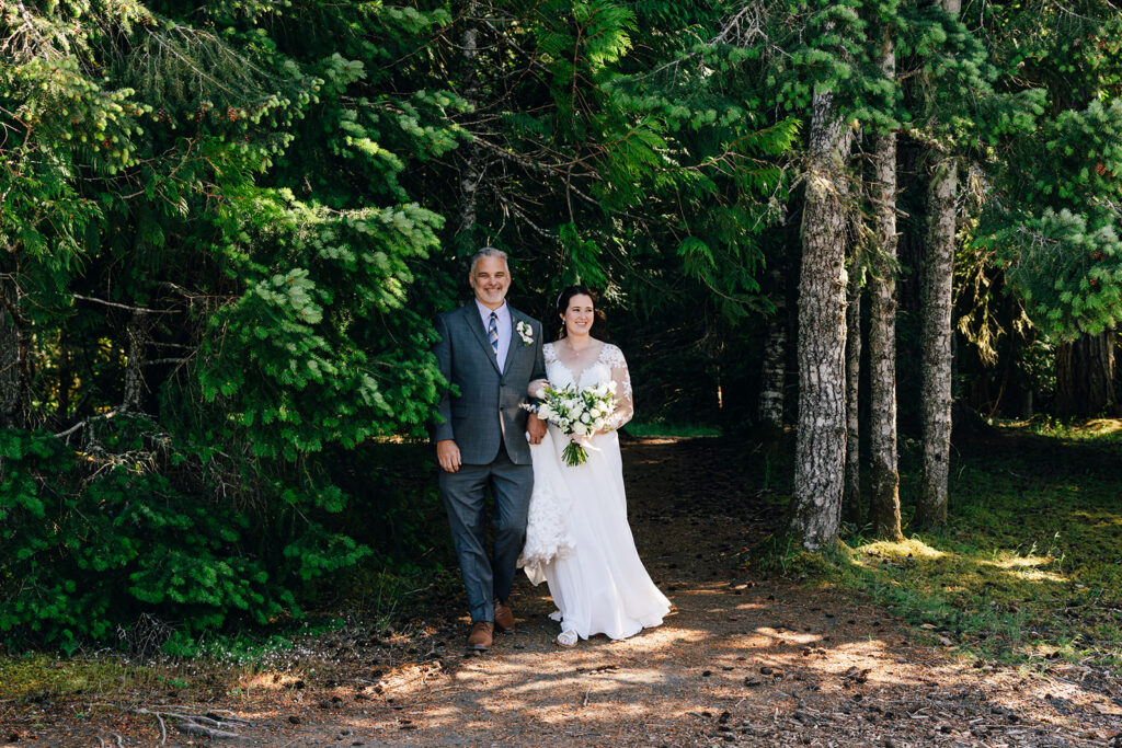 A father walks his daughter down the aisle at her intimate nature wedding in Olympic National Park.