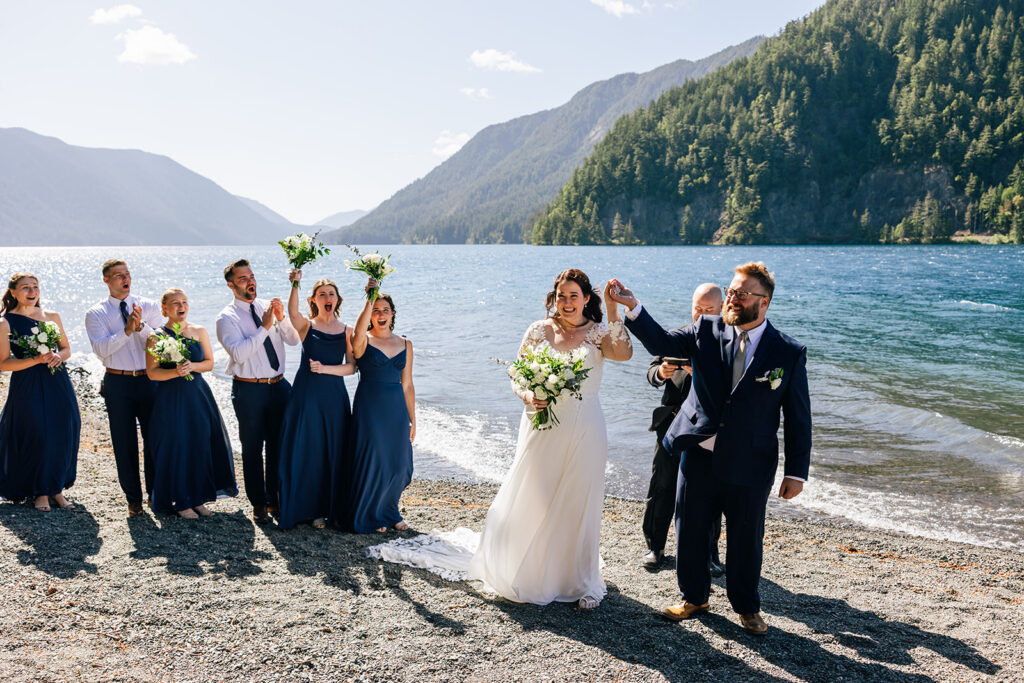 A wedding party celebrates a couple's ceremony on Lake Crescent in Olympic National Park.
