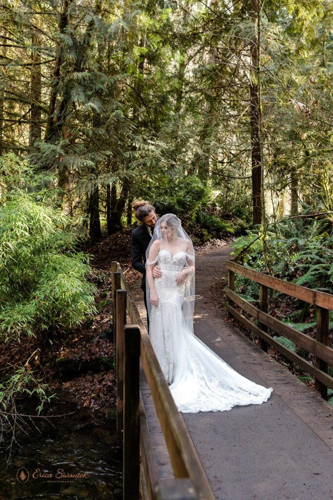 elopement couple snuggling during their winter elopement in the forest in pacific north west