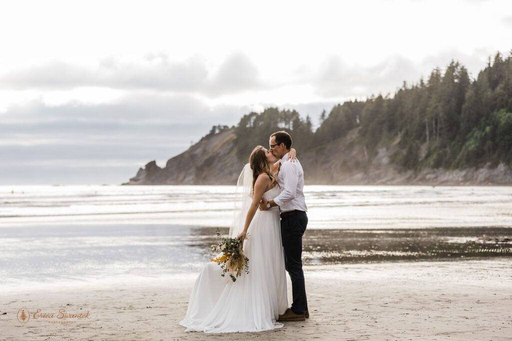 elopement couple kissing along the coast during their pnw coastal elopement