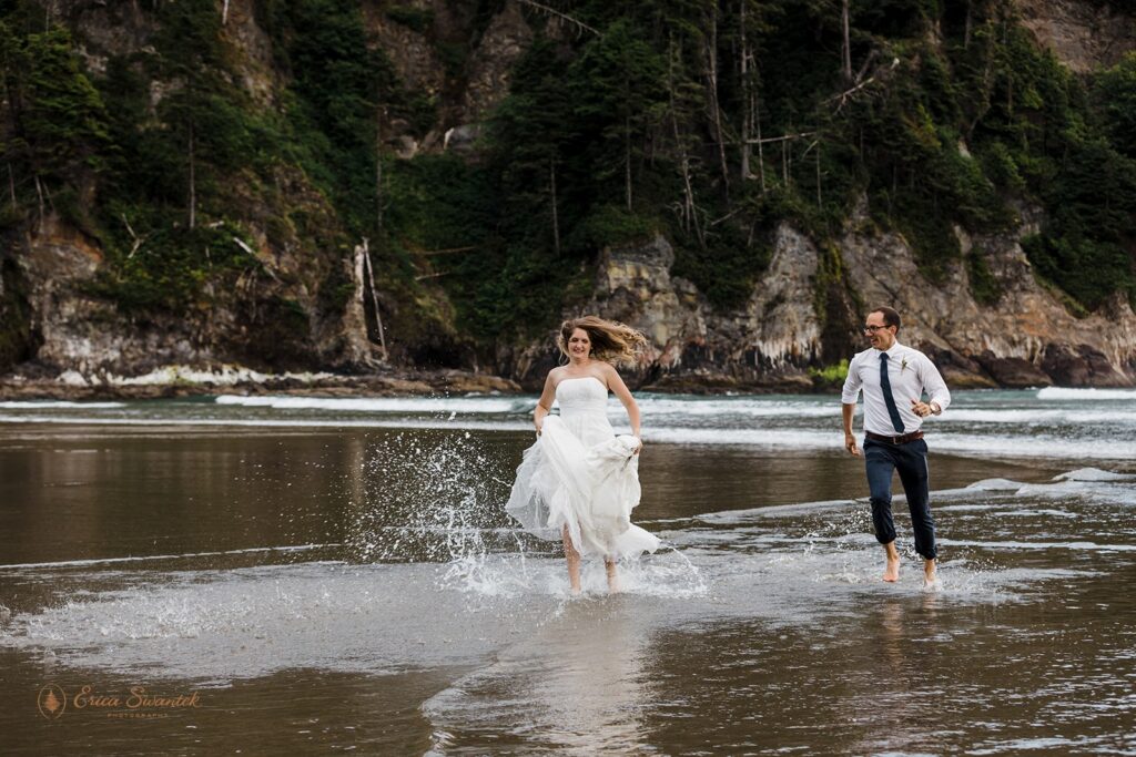 elopement couple running in the water during their pnw coastal elopement