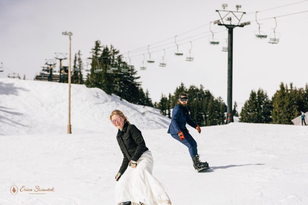 elopement couple snowboarding during a winter elopement in the pnw
