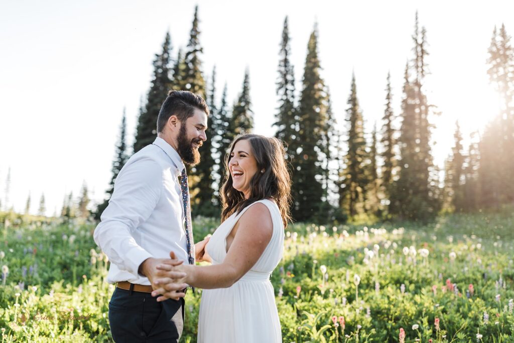 elopement couple snuggling in a wildflower field