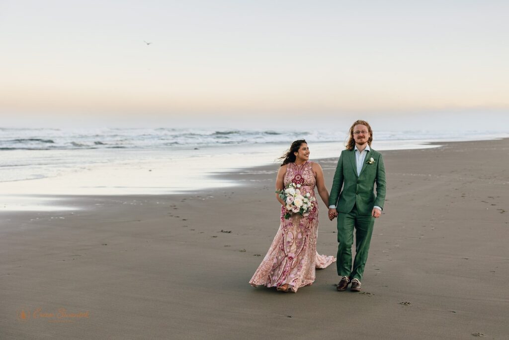 elopement couple walking along the coast during their pnw coastal elopement