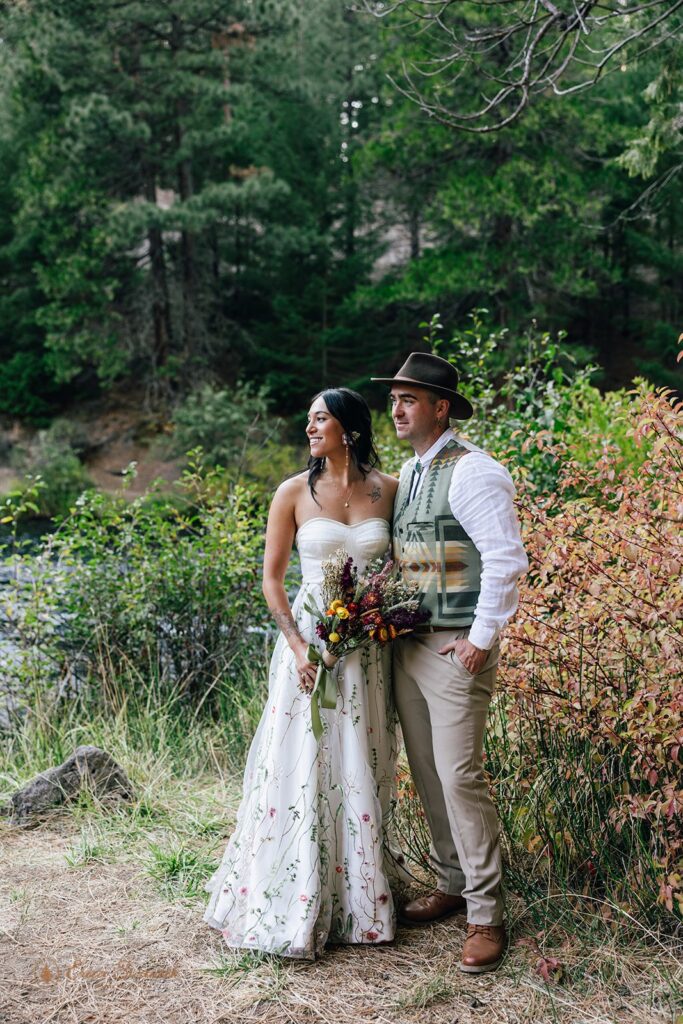 elopement couple surrounded by gorgeous fall landscapes in the forest