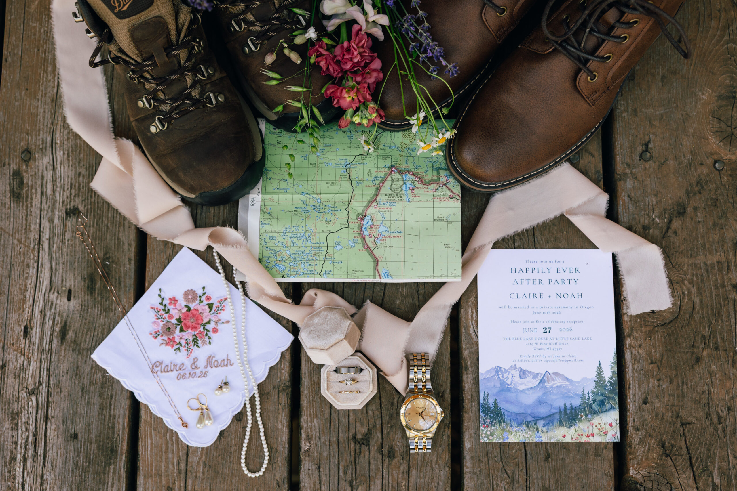 elopement day flatlay details, including hiking boots and forest map.