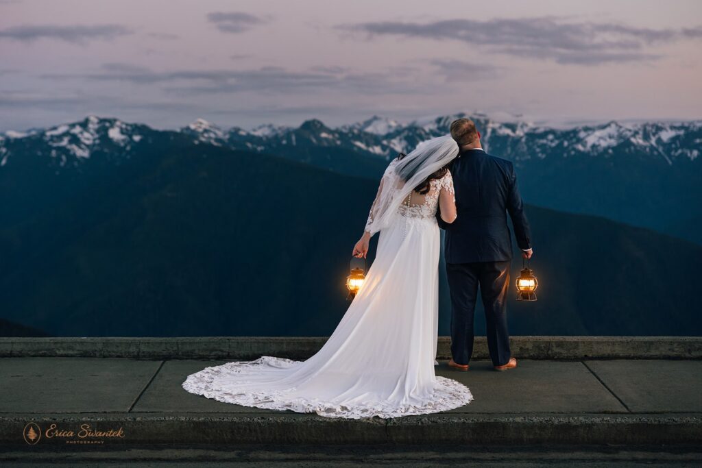 elopement couple snuggling with epic mountain views in the backdrop in the pacific north west