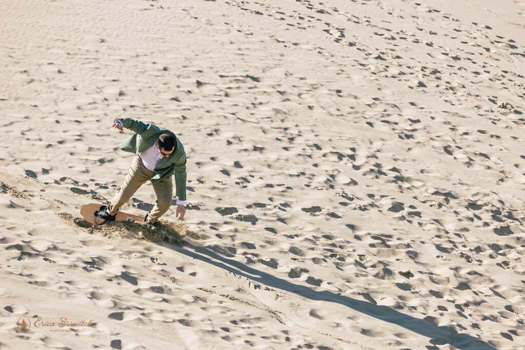 groom sandboarding during their adventure elopement day in the pnw