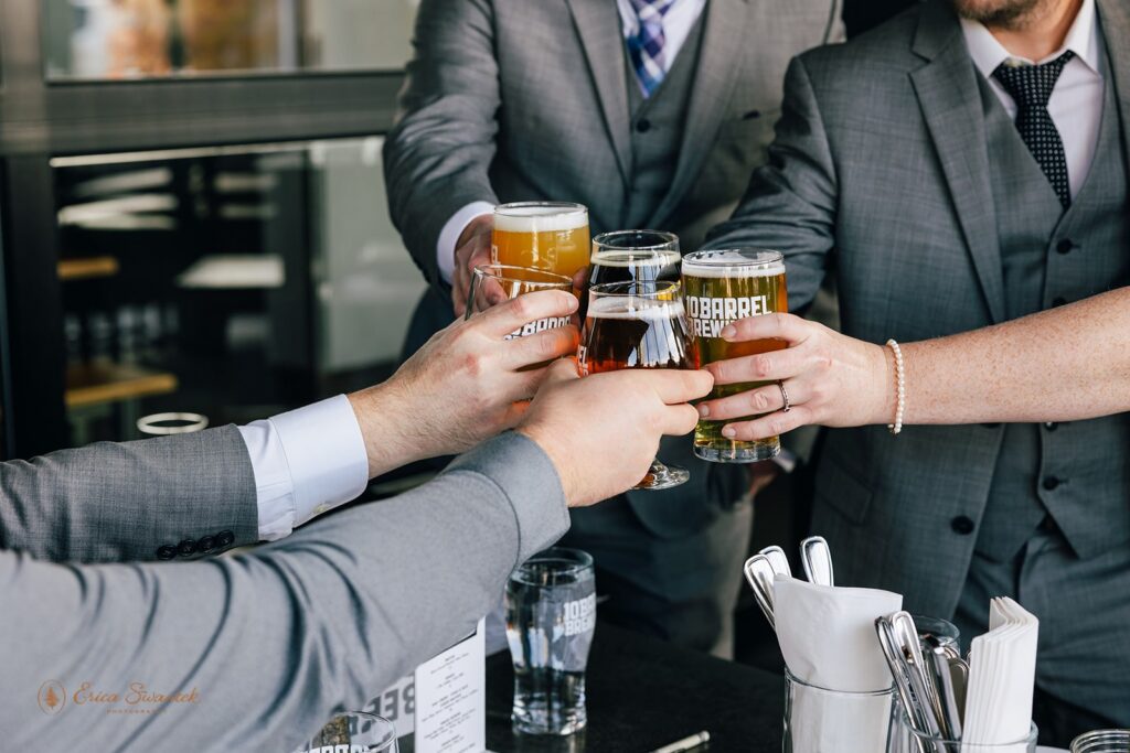 elopement couple and friends cheers with beers