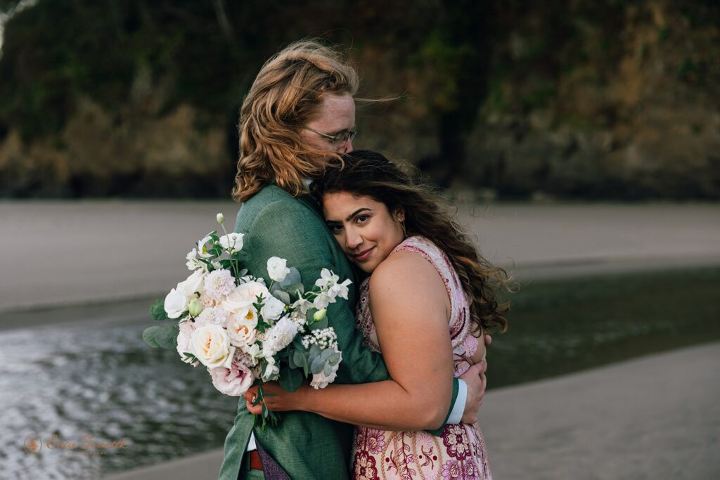 elopement couple hugging, bride holding a bouquet