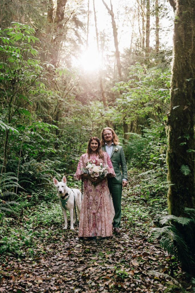 bride and groom and their dog in a forest during their pnw elopement