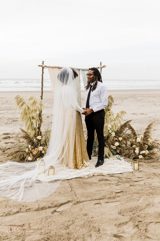 boho elopement ceremony with lush decor set up on the coast