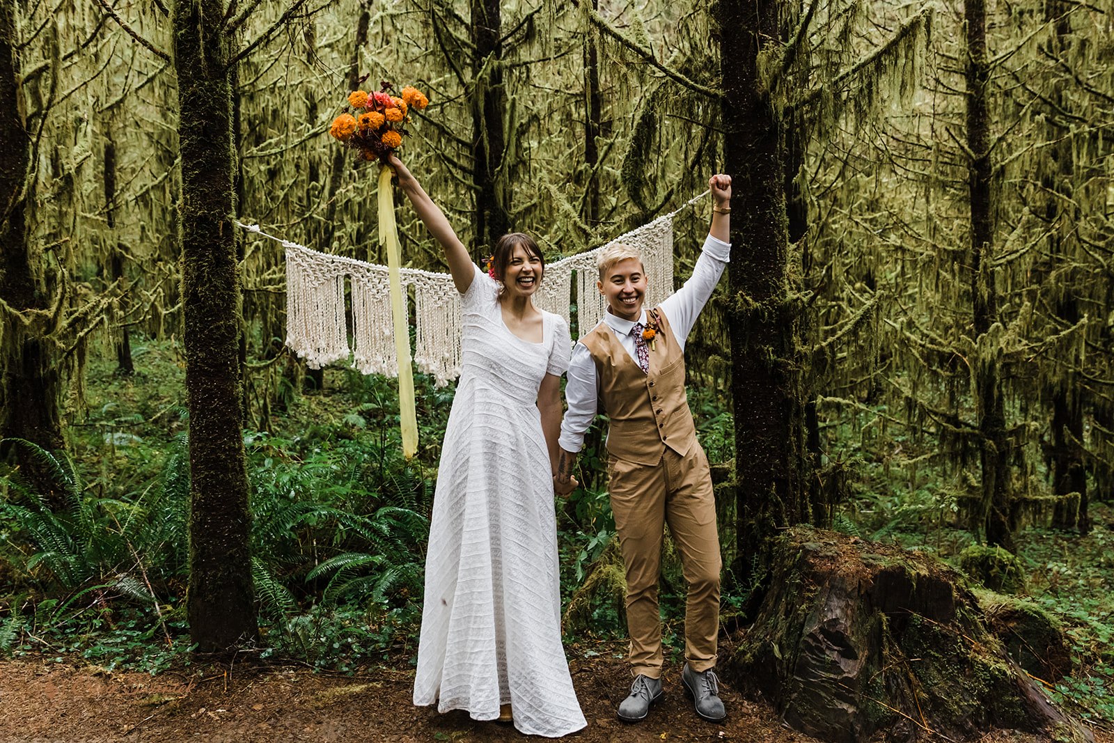 cheerful elopement couple after their elopement ceremony in a forest