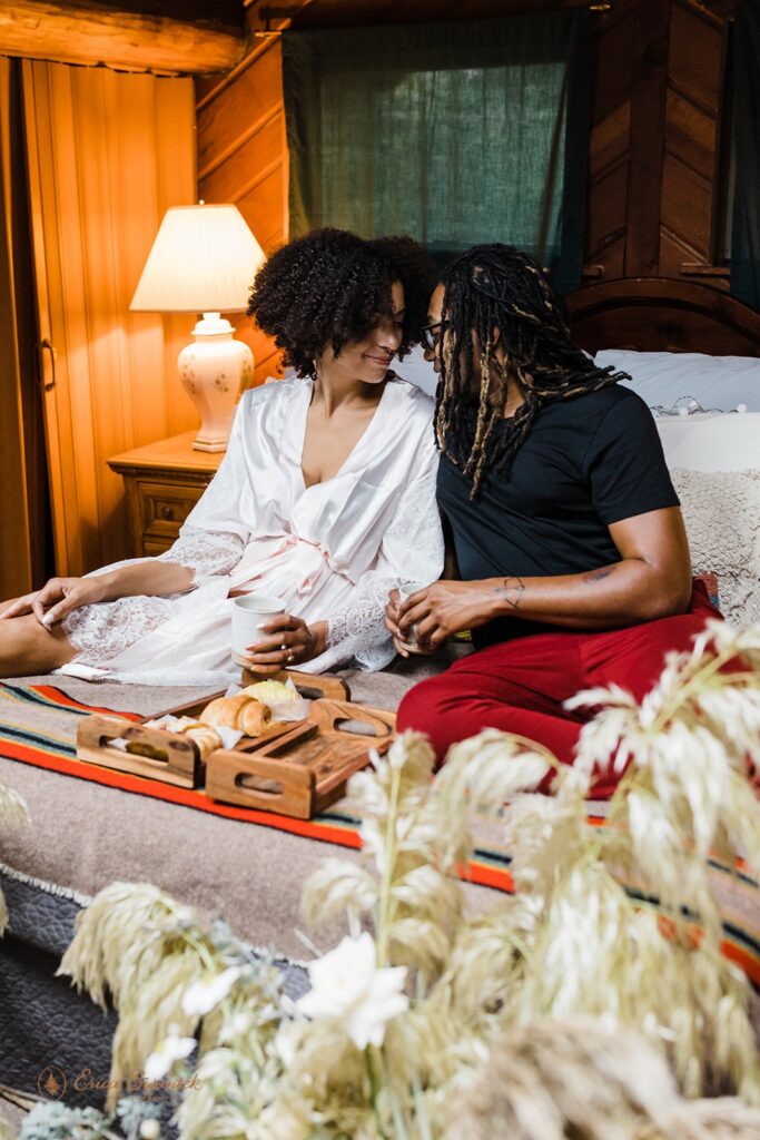 elopement couple snuggling on the bed at their airbnb