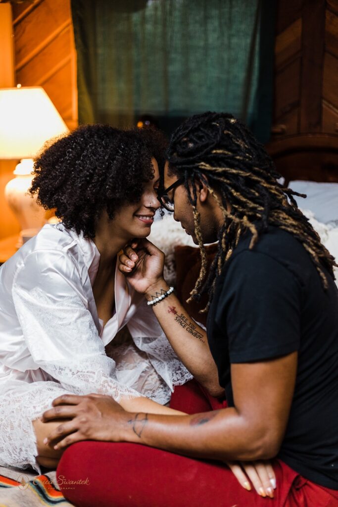 elopement couple snuggling on the bed at their airbnb