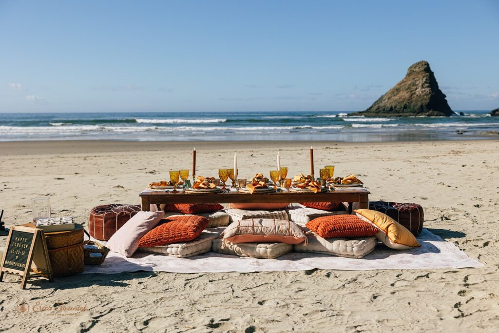 colorful elopement picnic set up on the oregon coast