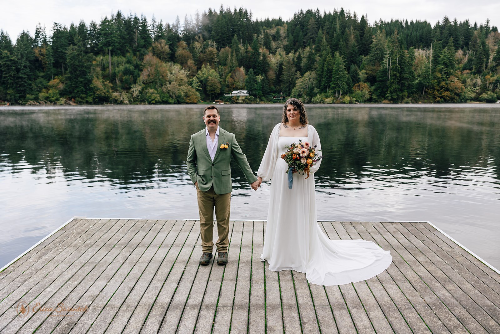elopement couple holding hands on a boat dock