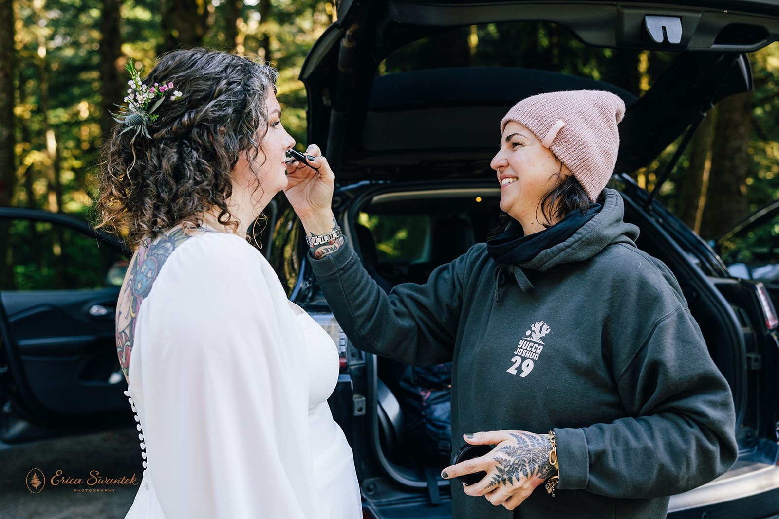 hair and make up artist helping the bride get ready for the day