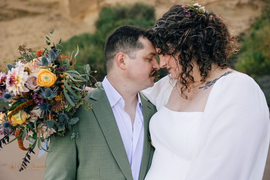 elopement couple hugging, bride holding a bouquet