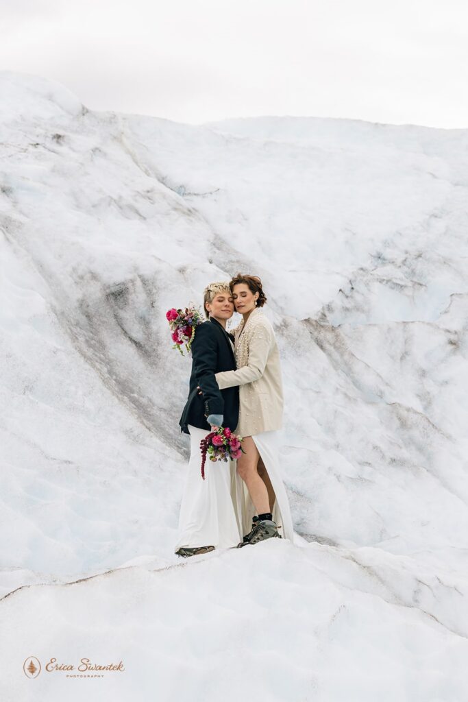 elopement couple hugging on top of a glacier