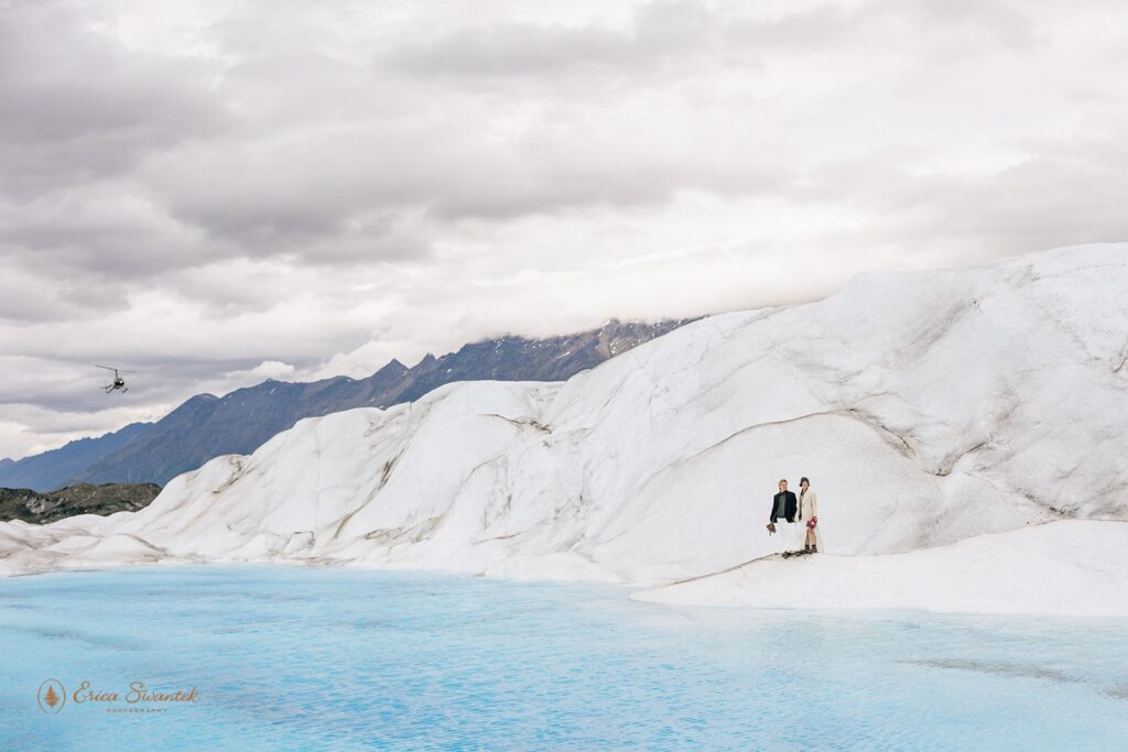 elopement couple standing on a glacier in alaska
