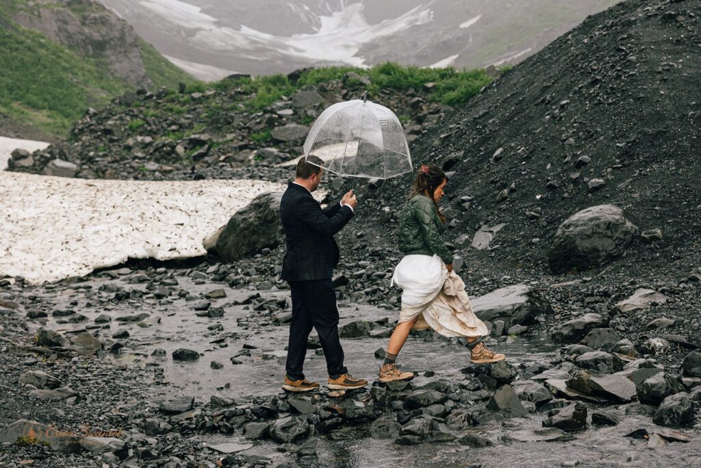 elopement couple walking on some rocks during alaska elopement