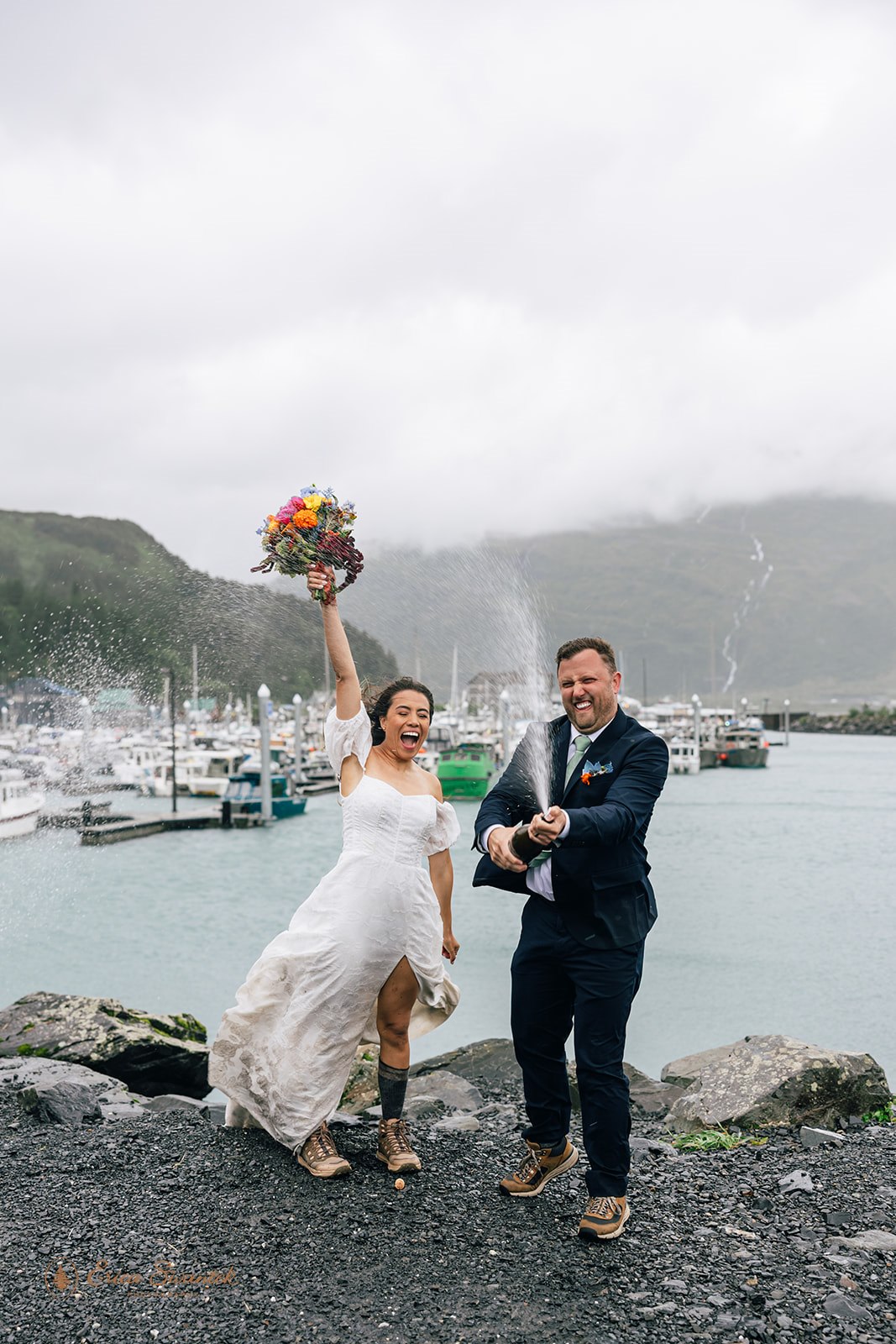elopement couple popping champagne in whittier, alaska