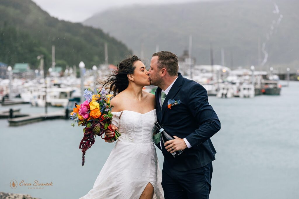 elopement couple popping champagne in whittier, alaska