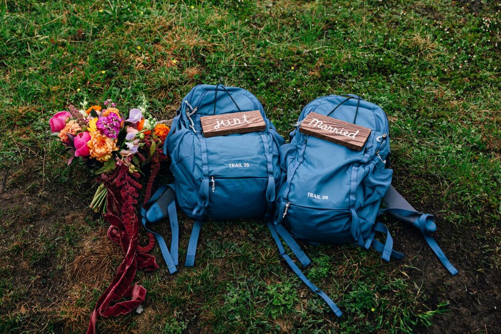 just married back packs and a colorful wedding bouquet
